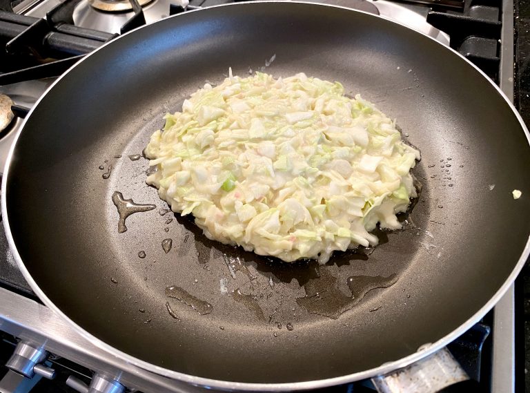 Photo of raw Okonomiyaki mixture in a frying pan