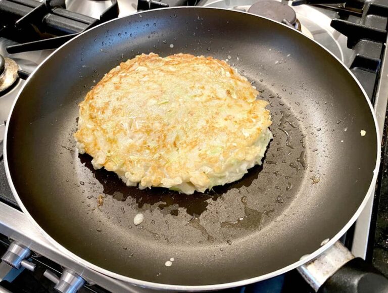 Photo of half cooked Okonomiyaki in a frying pan