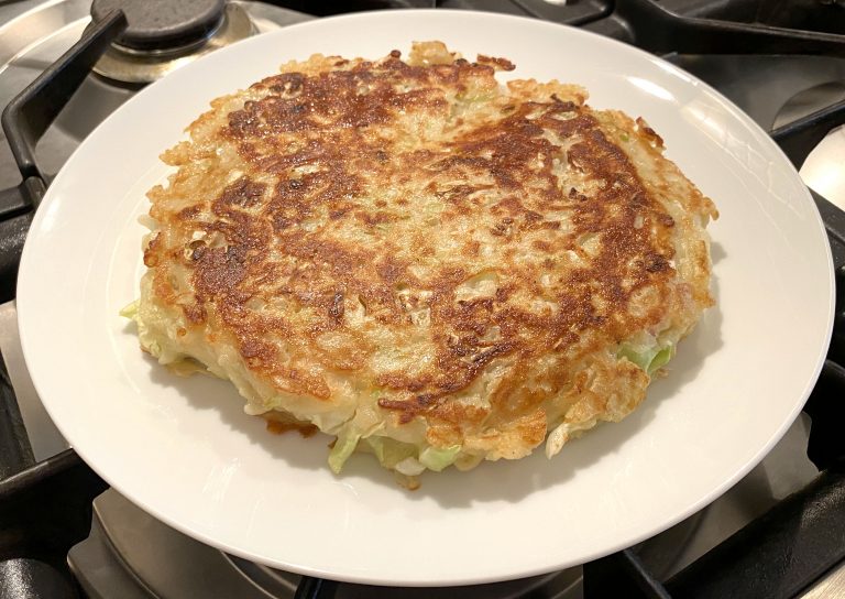Photo of fully cooked Okonomiyaki on a plate