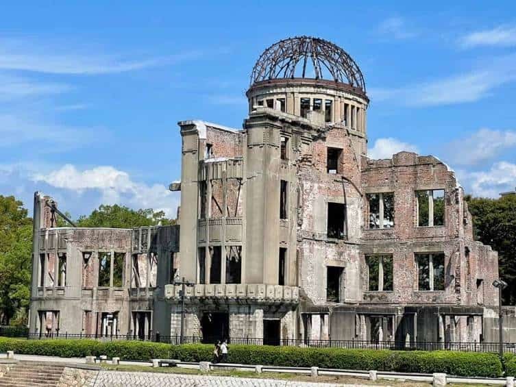 Close-up view of the historic Atomic Bomb Dome ruins in Hiroshima, Japan, showing the crumbling brick walls and exposed iron dome framework.
