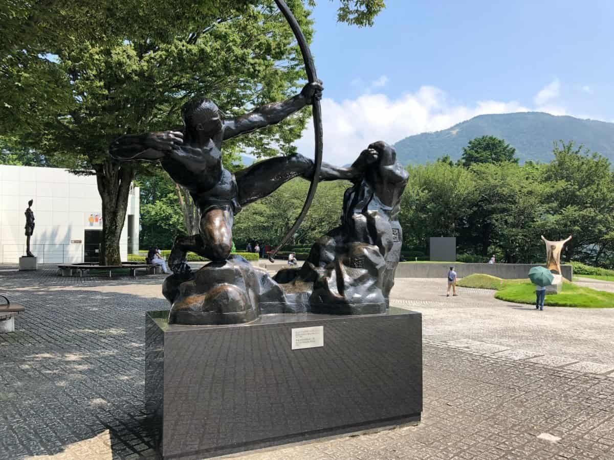 A bronze sculpture of Heracles the Archer (Héraklès archer) by Émile-Antoine Bourdelle displayed outdoors at the Hakone Open-Air Museum.